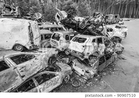 War in Ukraine: a dump of shot and burned cars in Irpin, Bucha district, black and white War in Ukraine: a dump of shot and burned cars in Irpin, Bucha district, black and white 90907510