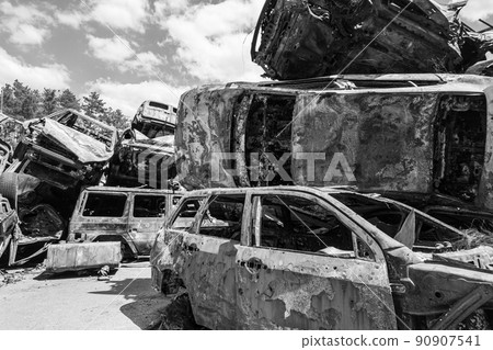 War-destroyed cars in Irpin, Bucha district, Ukraine, black and white 90907541