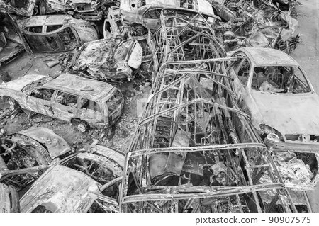 War in Ukraine: a dump of shot and burned cars in Irpin, Bucha district, black and white 90907575