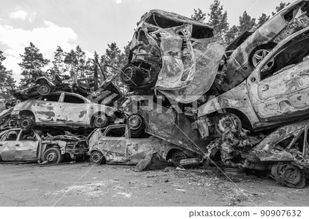 War-destroyed cars in Irpin, Bucha district, Ukraine, black and white War-destroyed cars in Irpin, Bucha district, Ukraine, black and white 90907632