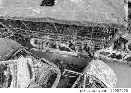 War in Ukraine: a dump of shot and burned cars in Irpin, Bucha district, black and white 90907976