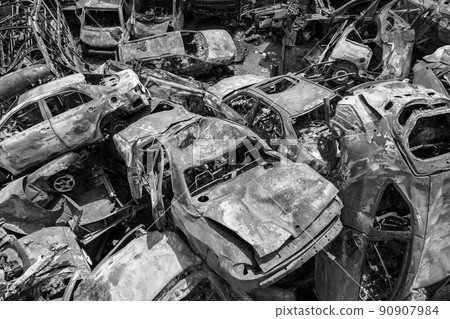 War in Ukraine: a dump of shot and burned cars in Irpin, Bucha district, black and white War in Ukraine: a dump of shot and burned cars in Irpin, Bucha district, black and white 90907984