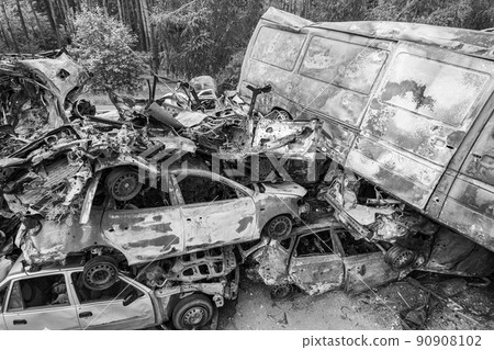 War-destroyed cars in Irpin, Bucha district, Ukraine, black and white 90908102