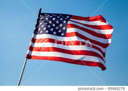 American flag waving on blue sky background American flag waving on blue sky background 90908276