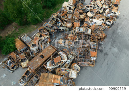 War-destroyed cars in Irpin, Bucha district, Ukraine 90909539