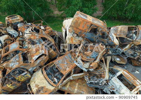 War-destroyed cars in Irpin, Bucha district, Ukraine 90909745
