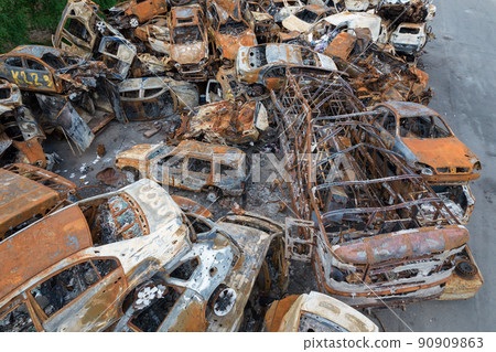 War-destroyed cars in Irpin, Bucha district, Ukraine 90909863