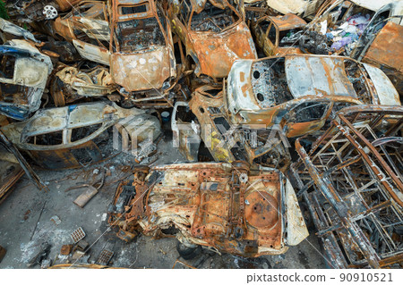 War-destroyed cars in Irpin, Bucha district, Ukraine 90910521