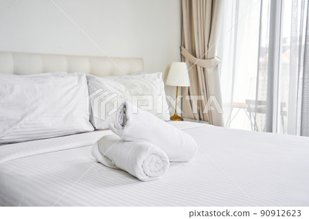 rolled up white towels on the hotel bed rolled up white towels on the hotel bed 90912623