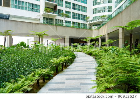 Green garden in the inner yard of residential building complex 90912627