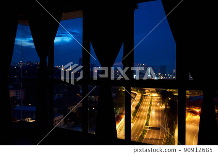Night view from the window of the apartment on a multi-lane highway in the direction of the metropolis. Night view. Night view from the window of the apartment on a multi-lane highway in the direction of the metropolis. Night view. 90912685