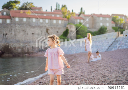 Mother and two children daughter and son tourists on background of beautiful view St. Stephen island, Sveti Stefan on the Budva Riviera, Budva, Montenegro. Travel to Montenegro concept Mother and two children daughter and son tourists on background of beautiful view St. Stephen island, Sveti Stefan on the Budva Riviera, Budva, Montenegro. Travel to Montenegro concept 90913261