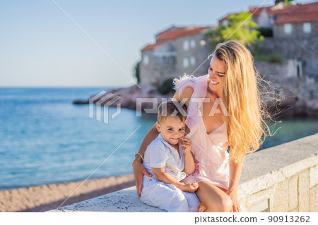 Mother and son tourists on background of beautiful view St. Stephen island, Sveti Stefan on the Budva Riviera, Budva, Montenegro. Travel to Montenegro concept 90913262