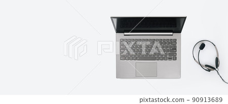 Laptop with headphones on white desk banner Laptop with headphones on white desk banner 90913689