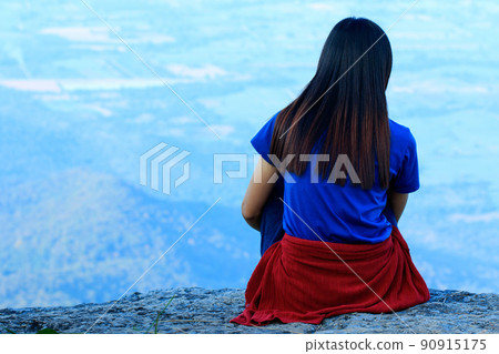 The woman was sitting back on the rock. The woman was sitting back on the rock. 90915175