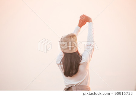 Behind the woman, a white shirt that is raising his hand Behind the woman, a white shirt that is raising his hand 90915733