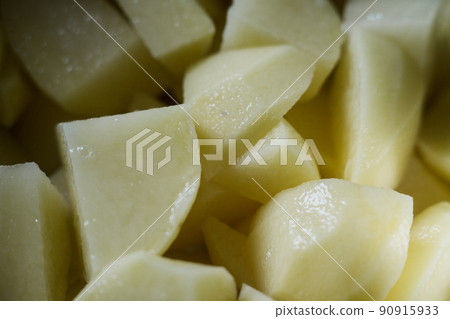 raw potatoes in a casserole on the stove 90915933