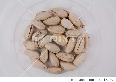 the last closed pistachios in a pack on a white background 90916229