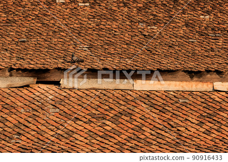 Old clay tiles on the roof of the Thai temple Old clay tiles on the roof of the Thai temple 90916433