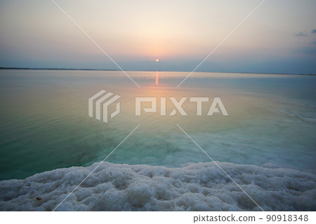 Beautiful sunrise at Dead Sea in Israel with rocks of salt at foreground Beautiful sunrise at Dead Sea in Israel with rocks of salt at foreground 90918348