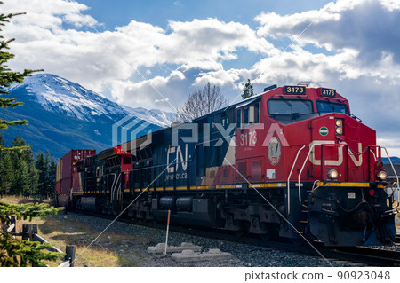 Jasper, Alberta, Canada - May 1 2021 : Canadian National Railway freight train. Canadian Rockies, Jasper National Park. 90923048