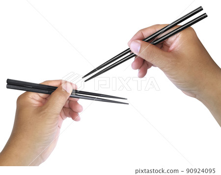 Hand holding wooden chopsticks isolated on white background Hand holding wooden chopsticks isolated on white background 90924095