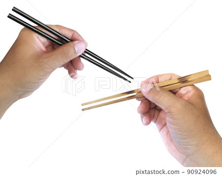 Hand holding wooden chopsticks isolated on white background 90924096