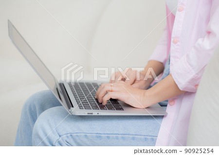 Closeup hands business woman work from home with laptop computer online to internet on sofa. 90925254