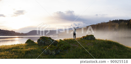 Adventurous Woman Standing in Nature. Cloudy Sunset Sky. Adventurous Woman Standing in Nature. Cloudy Sunset Sky. 90925518
