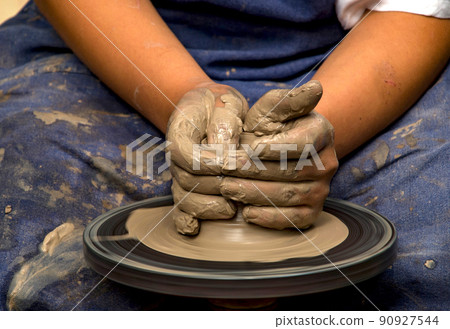 Potter modeling ceramic pot from clay on a potter's wheel. Workshop, art concept Potter modeling ceramic pot from clay on a potter's wheel. Workshop, art concept 90927544