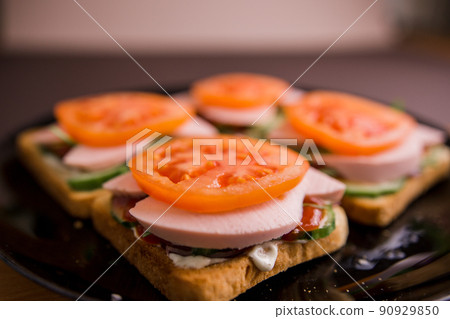 delicious sandwiches with tomato and sausage on a plate 90929850
