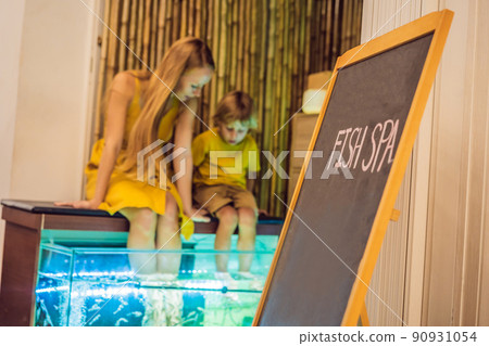 Mom and son at the fish spa Mom and son at the fish spa 90931054