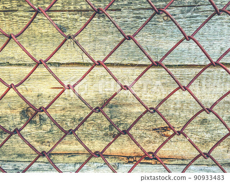 texture, background. natural, processed wood. the texture of the logs, the trees are behind a metal mesh. farm fence 90933483