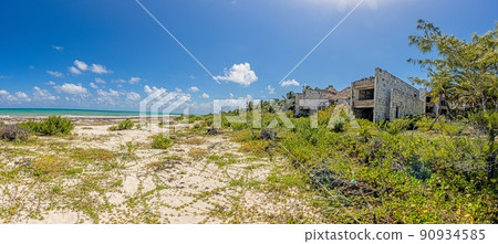 Picture of a destroyed, overgrown and left to itself hotel complex on a beach Picture of a destroyed, overgrown and left to itself hotel complex on a beach 90934585