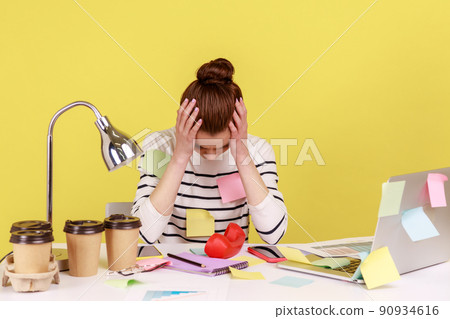 Tired exhausted overworked woman office worker covered with sticky notes, clasping head, thinking desperate, suffering headache. Indoor studio studio shot isolated on yellow background. 90934616
