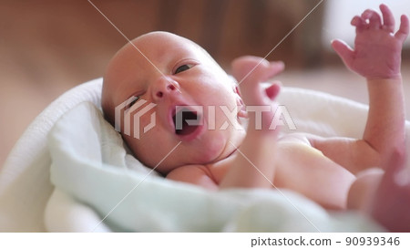 newborn. baby newborn a close-up lies looking at the camera in the hospital maternity hospital. happy family lifestyle baby dream concept. cute newborn baby wrapped in a blanket newborn. baby newborn a close-up lies looking at the camera in the hospital maternity hospital. happy family lifestyle baby dream concept. cute newborn baby wrapped in a blanket 90939346