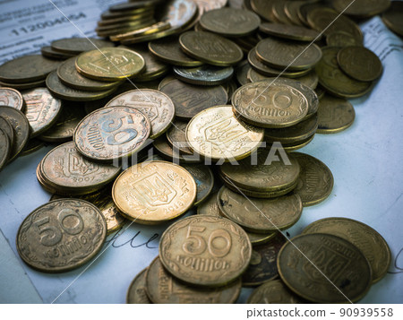 Ukrainian coins lie in a pile on documents Ukrainian coins lie in a pile on documents 90939558