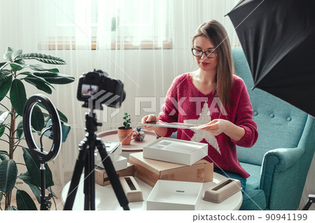woman blogger makes video of unpacking gadgets at home 90941199