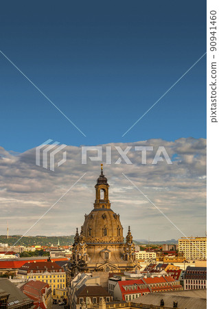 Cover page with bird view of the church of our Lady (Frauenkirche) at Neumarkt square in historical downtown of Dresden in summer with blue sky and sunset, Germany. Cover page with bird view of the church of our Lady (Frauenkirche) at Neumarkt square in historical downtown of Dresden in summer with blue sky and sunset, Germany. 90941460
