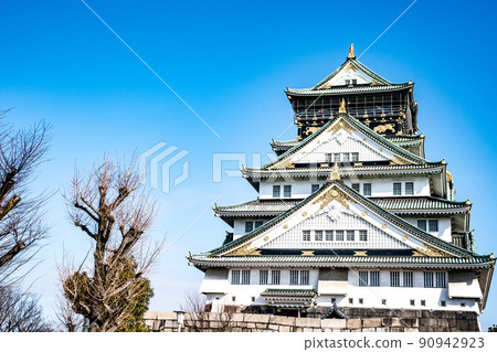 Japanese, Tourists, Travelers walked around Osaka Castle in Mar 2018 with dry tree around, Oaska, Japan. 90942923