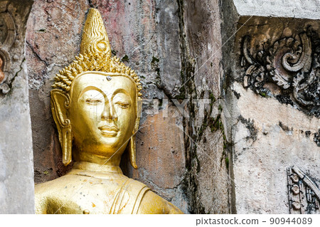 Great Gold Buddha statue with old background wall. Great Gold Buddha statue with old background wall. 90944089