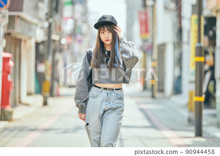 Gen Z women standing looking at the camera 90944458