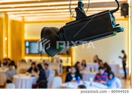 LED spotlight in the seminar classroom hall with blur people behind. 90944926