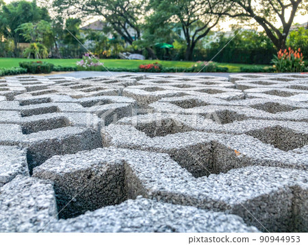 gray color stone brick block floor tile with green grass and sand as background or texture. 90944953