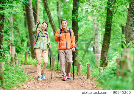 Senior couple walking in the mountains 90945200