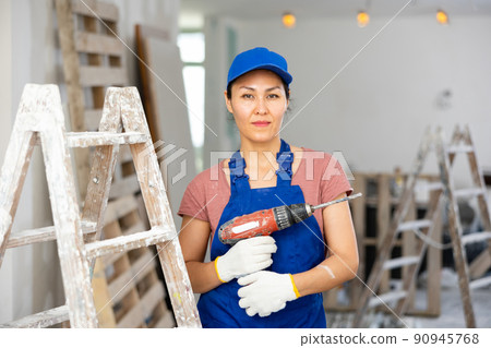 Portrait of asian woman builder with drill Portrait of asian woman builder with drill 90945768
