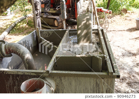 Rotary drilling rig at a construction site Rotary drilling rig at a construction site 90946273