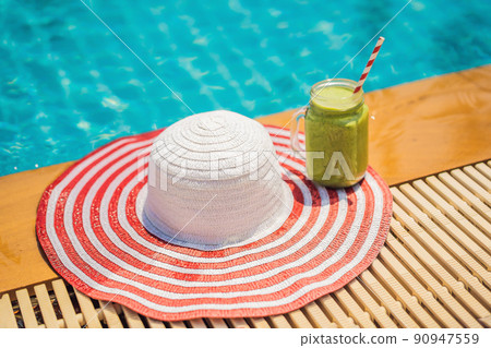 Green smoothies of spinach and banana on the background of the pool. Healthy food, healthy smoothies 90947559