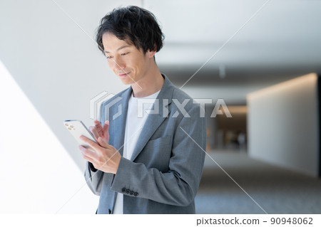 A young office casual businessman talking on a smartphone Shooting cooperation "LINK FOREST" A young office casual businessman talking on a smartphone Shooting cooperation "LINK FOREST" 90948062