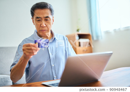 Senior man shopping online Senior man shopping online 90948467